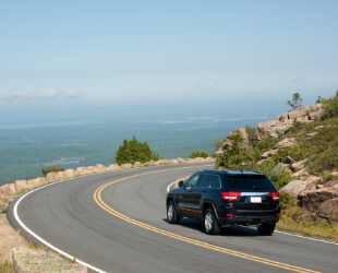 Car driving through Acadia National Park in Maine